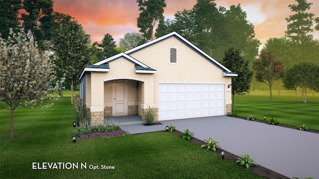 view of front of home featuring a garage and a yard