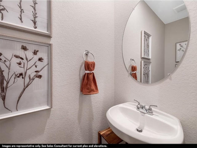bathroom featuring visible vents and a sink