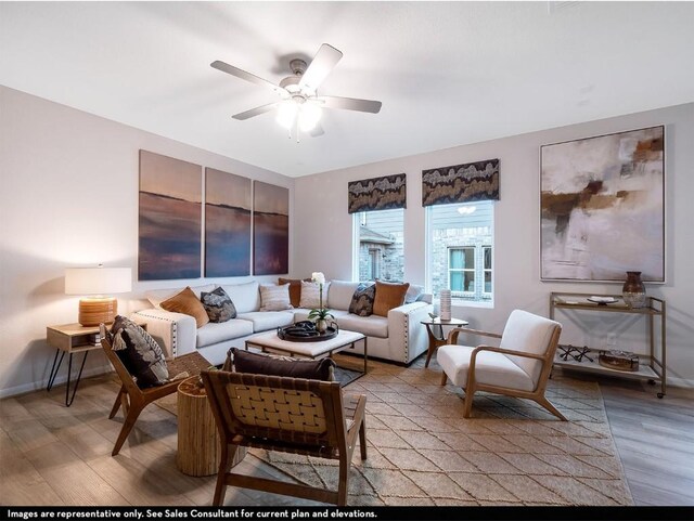 living room featuring a ceiling fan, baseboards, and light wood-style floors