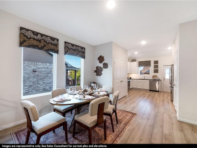 dining area featuring light wood finished floors, recessed lighting, and baseboards