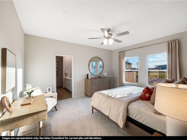 carpeted bedroom with ensuite bath and ceiling fan