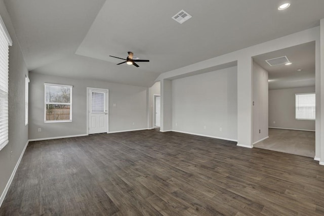 unfurnished living room featuring vaulted ceiling, ceiling fan, and dark wood-type flooring