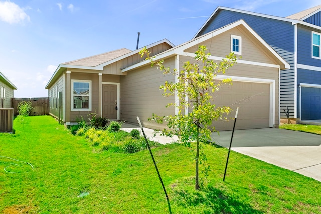 view of front of home featuring central AC, a front yard, and a garage