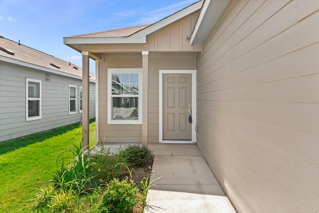 entrance to property with a lawn