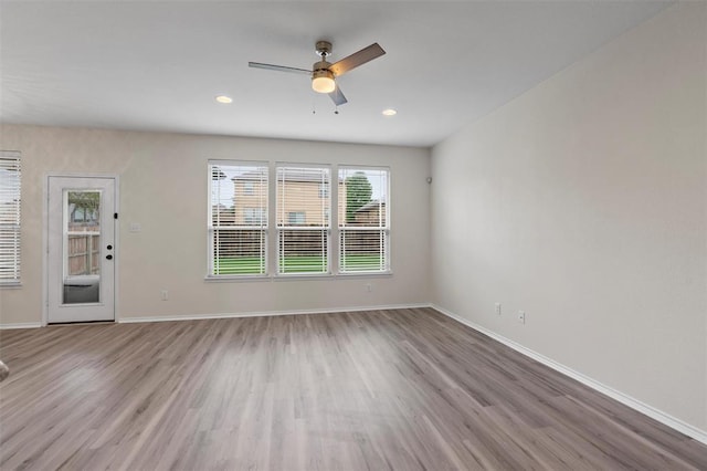 unfurnished living room with a ceiling fan, recessed lighting, baseboards, and wood finished floors