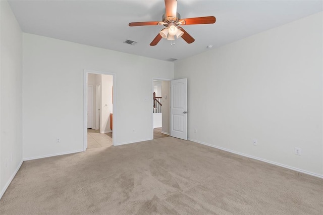 unfurnished bedroom with light carpet, ensuite bath, and ceiling fan