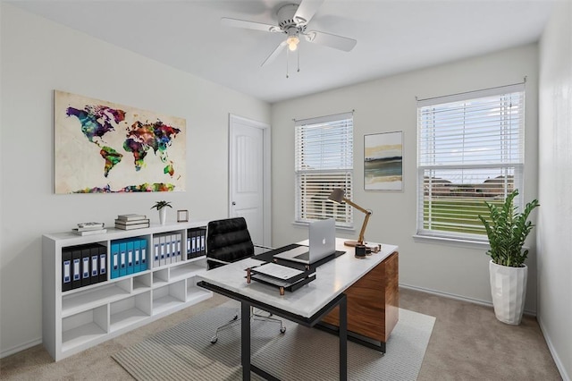 office space with light carpet and ceiling fan