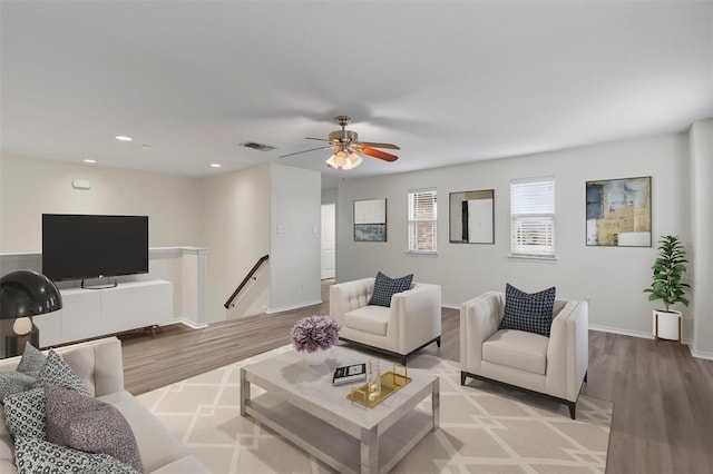 living room with ceiling fan and light wood-type flooring