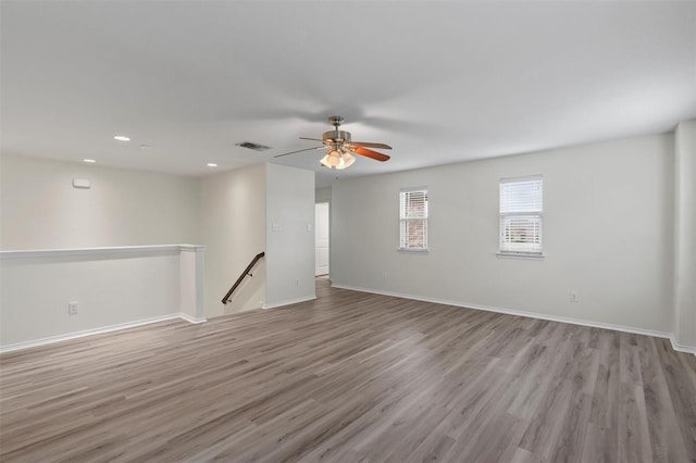 spare room featuring light hardwood / wood-style floors and ceiling fan