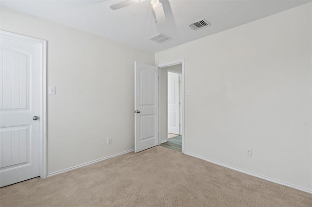 carpeted empty room with ceiling fan