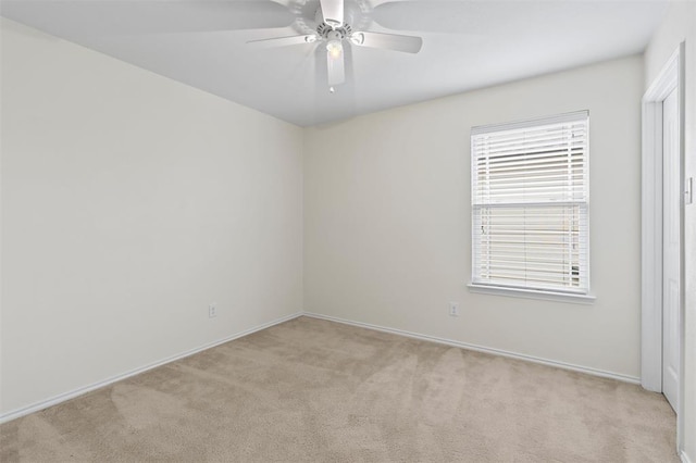 empty room with ceiling fan and light colored carpet