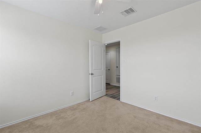 unfurnished room featuring light carpet and ceiling fan