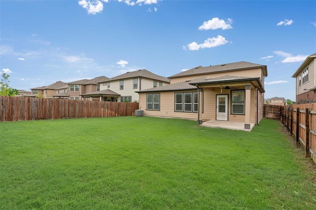 rear view of property featuring a patio area and a yard