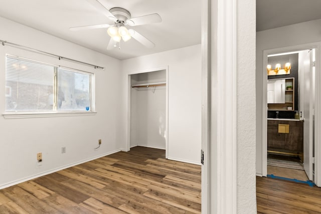 unfurnished bedroom featuring ceiling fan, wood-type flooring, and a closet