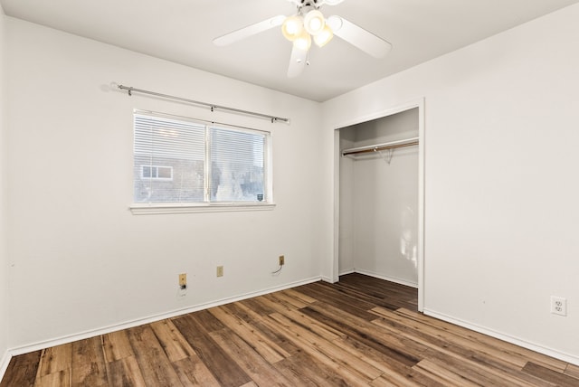 unfurnished bedroom with a closet, ceiling fan, and dark hardwood / wood-style flooring