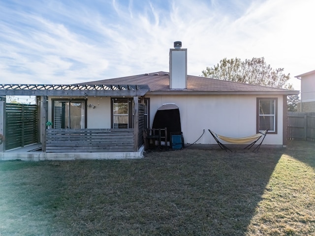 rear view of property featuring a yard