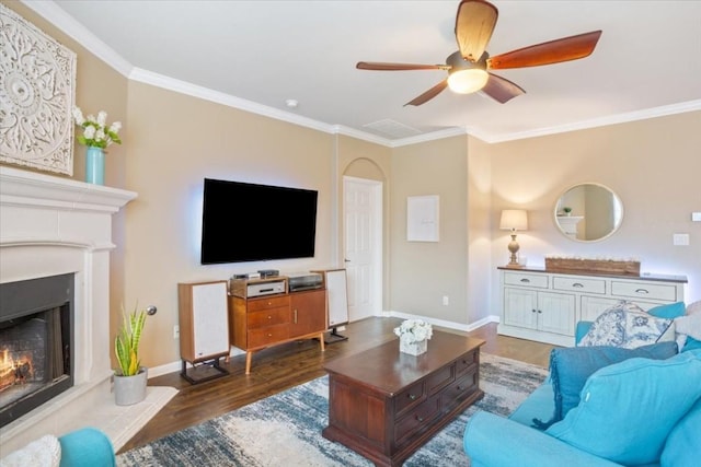 living room featuring ornamental molding, dark wood-type flooring, and ceiling fan