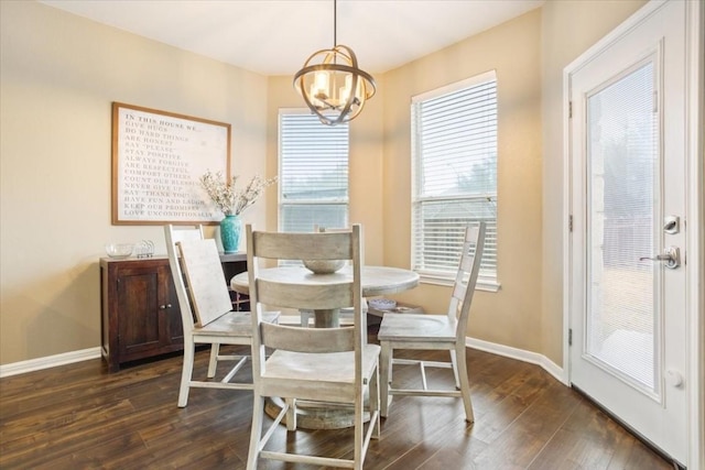 dining space featuring dark wood-type flooring and a chandelier