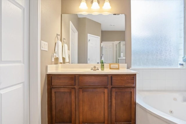 bathroom with vanity and separate shower and tub