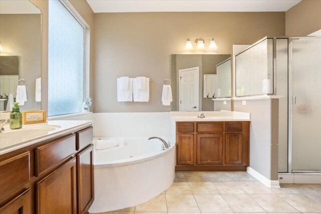 bathroom with independent shower and bath, vanity, and tile patterned flooring