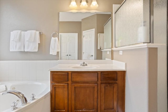 bathroom with vanity and independent shower and bath