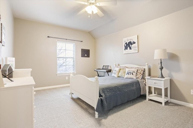 carpeted bedroom with ceiling fan and vaulted ceiling