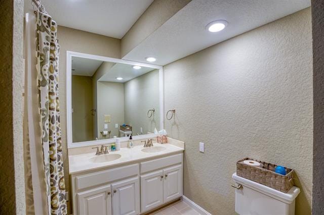 bathroom with tile patterned flooring and vanity