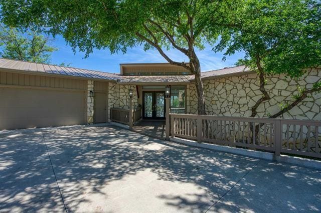 view of front of property featuring french doors and a garage