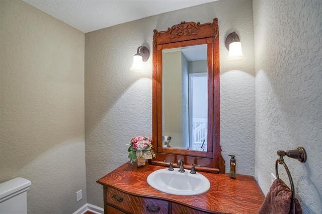 bathroom featuring vanity and toilet