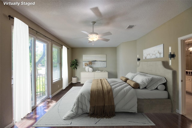 bedroom featuring access to outside, a textured ceiling, ceiling fan, and wood-type flooring