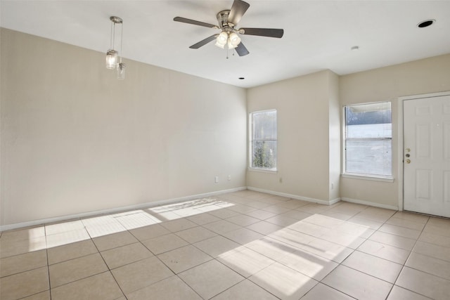 tiled spare room featuring ceiling fan