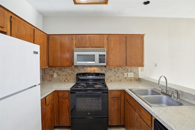 kitchen featuring tasteful backsplash, sink, and black appliances