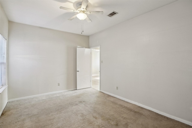 carpeted empty room featuring ceiling fan