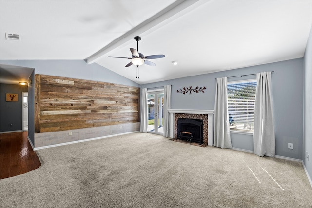 unfurnished living room featuring ceiling fan, carpet floors, and lofted ceiling with beams