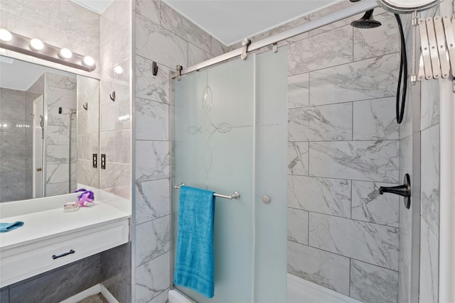 bathroom featuring vanity and a shower with door