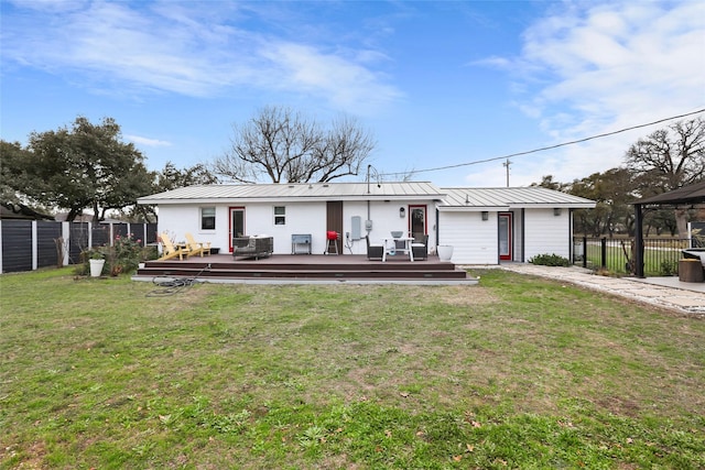 back of property with a gazebo, a deck, and a yard