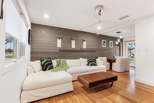 living room featuring wood-type flooring and wood walls