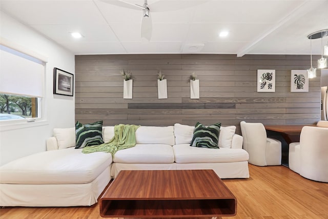 living room featuring hardwood / wood-style floors and wood walls