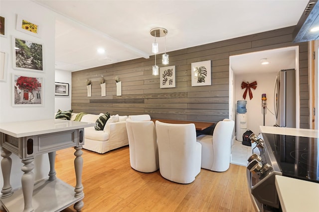 living room featuring light hardwood / wood-style floors and wooden walls