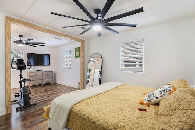 bedroom with ceiling fan and dark wood-type flooring