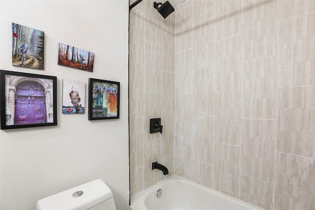 bathroom featuring tiled shower / bath combo and toilet