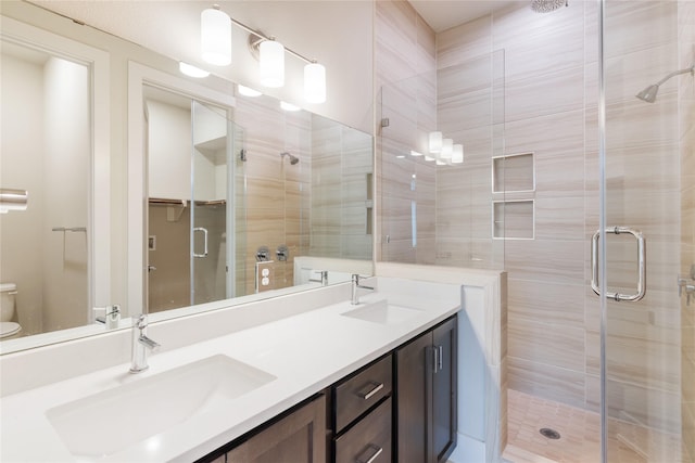 bathroom featuring vanity, toilet, and walk in shower