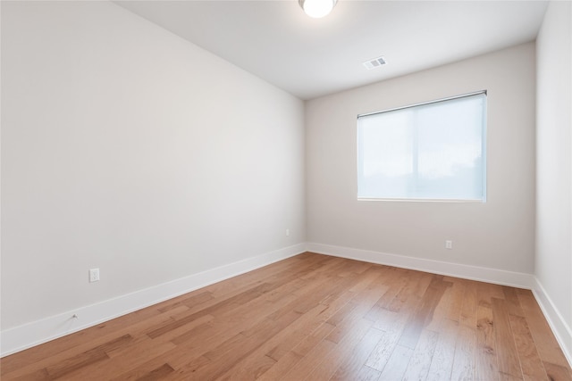 spare room with hardwood / wood-style flooring