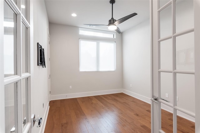 empty room featuring ceiling fan and hardwood / wood-style floors