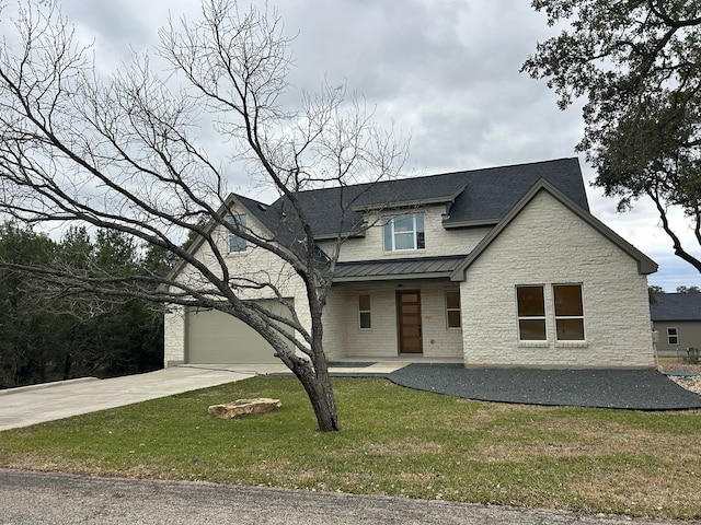 view of front of home featuring a garage and a front yard