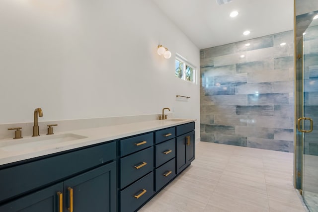 bathroom featuring a shower with door, vanity, and tile patterned floors