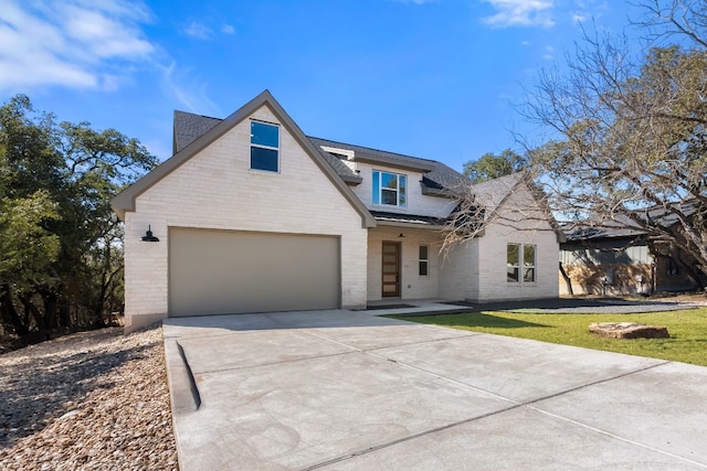 view of front of house featuring a garage and a front yard