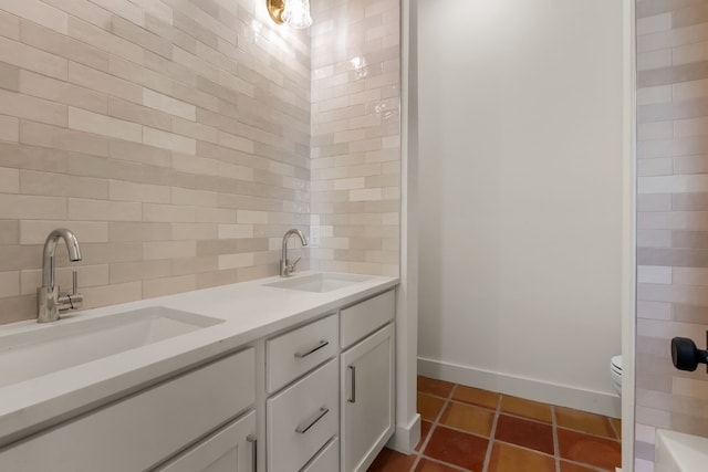 bathroom with vanity, tasteful backsplash, tile patterned floors, and toilet