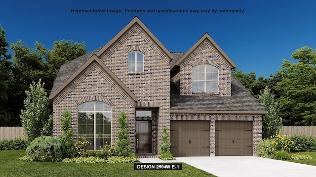 view of front of home with a front lawn and a garage