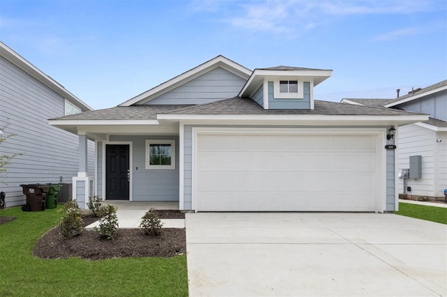 view of front of home featuring a front yard and a garage